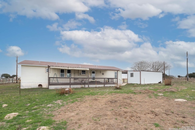 rear view of house with a lawn and a wooden deck