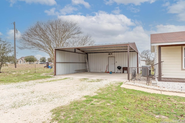 view of outbuilding featuring cooling unit and dirt driveway