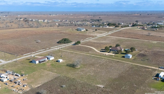 birds eye view of property with a rural view