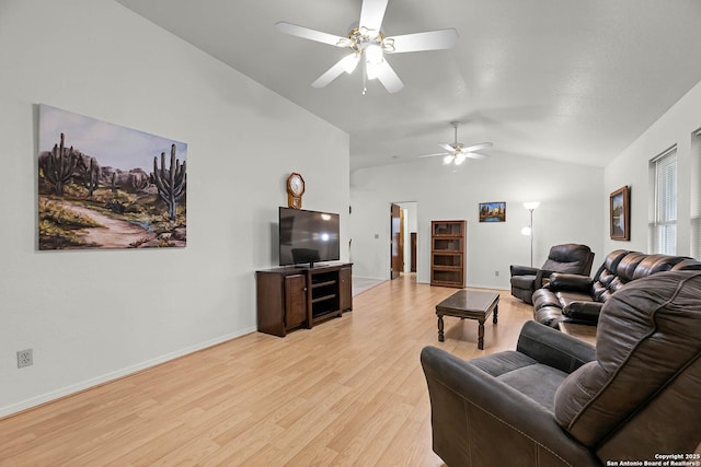 living area with vaulted ceiling, light wood-type flooring, a ceiling fan, and baseboards