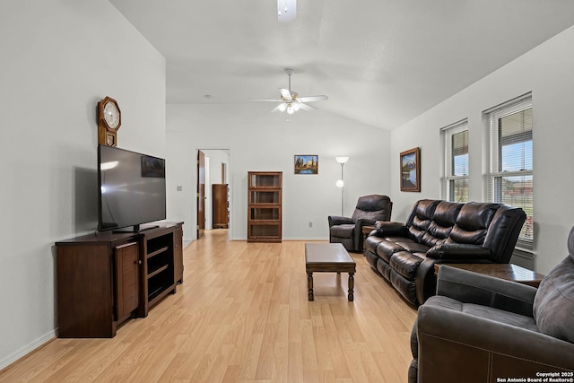 living area with lofted ceiling, light wood-style floors, ceiling fan, and baseboards