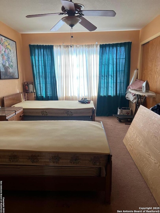 bedroom featuring carpet and a ceiling fan