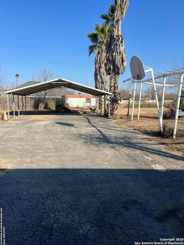 exterior space with driveway and a detached carport