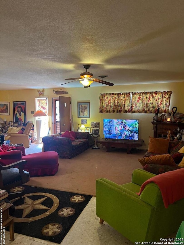 living room with a textured ceiling, carpet, and a ceiling fan