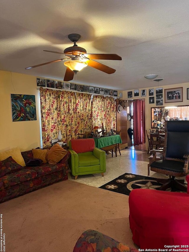 living area with a textured ceiling and a ceiling fan