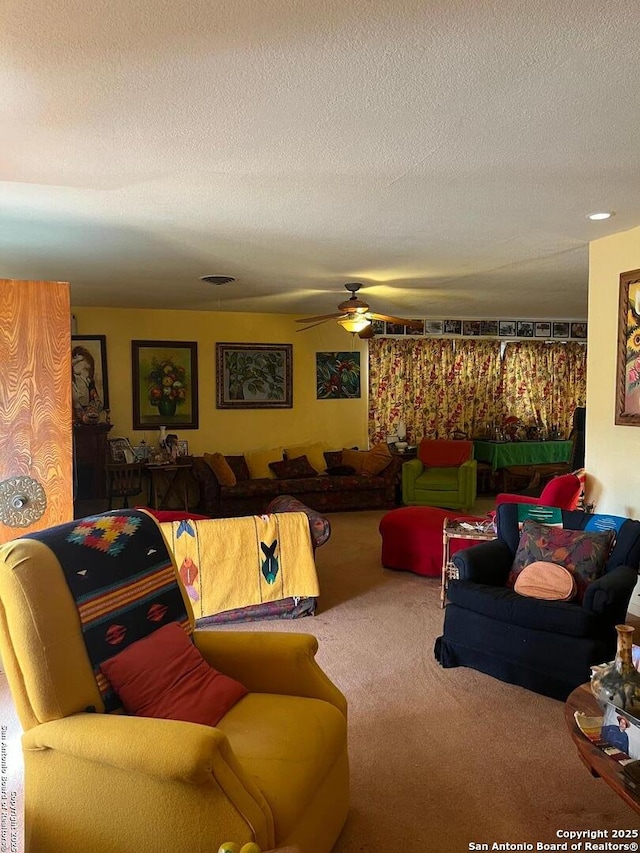 carpeted living area featuring a ceiling fan and a textured ceiling