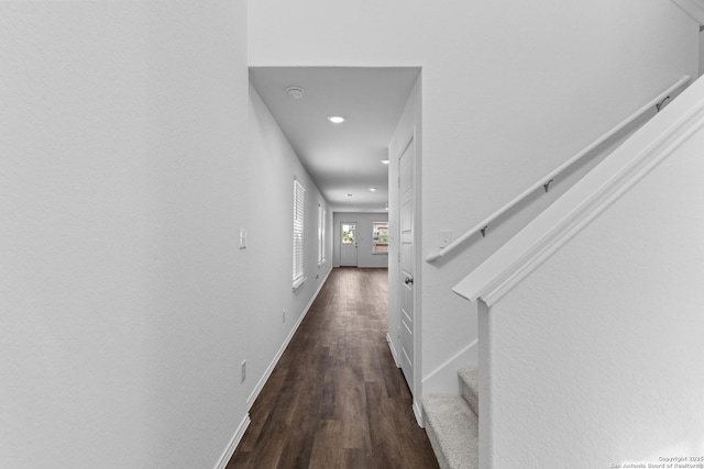 hall with stairs, baseboards, and dark wood-type flooring