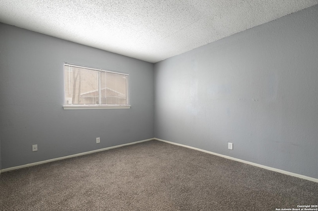 carpeted empty room with baseboards and a textured ceiling