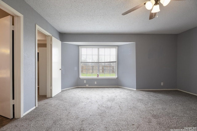 unfurnished bedroom featuring carpet flooring, a textured ceiling, and baseboards