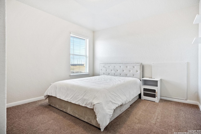 carpeted bedroom featuring baseboards