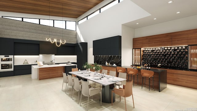 dining room with light tile patterned floors and a towering ceiling