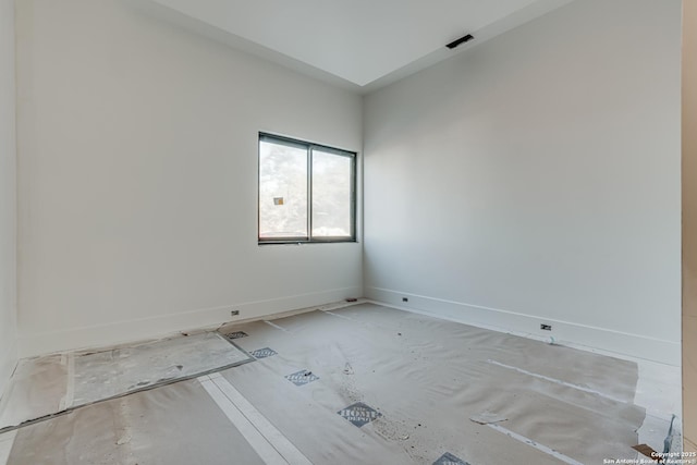 unfurnished room with baseboards