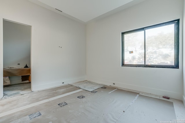 spare room featuring baseboards