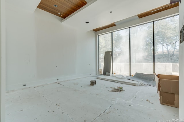 spare room with baseboards, wood ceiling, and a healthy amount of sunlight