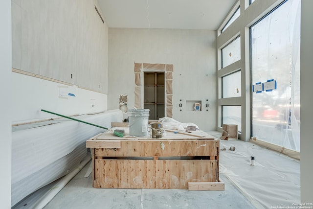 interior space with modern cabinets, light brown cabinets, light countertops, and unfinished concrete floors