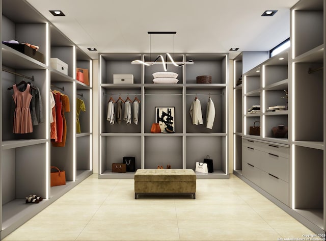 walk in closet with light tile patterned flooring