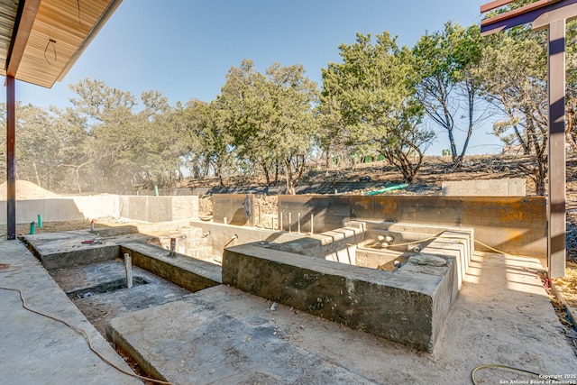 view of swimming pool with an outdoor kitchen and fence