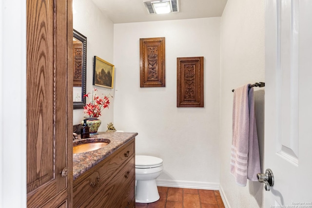 bathroom featuring baseboards, visible vents, vanity, and toilet