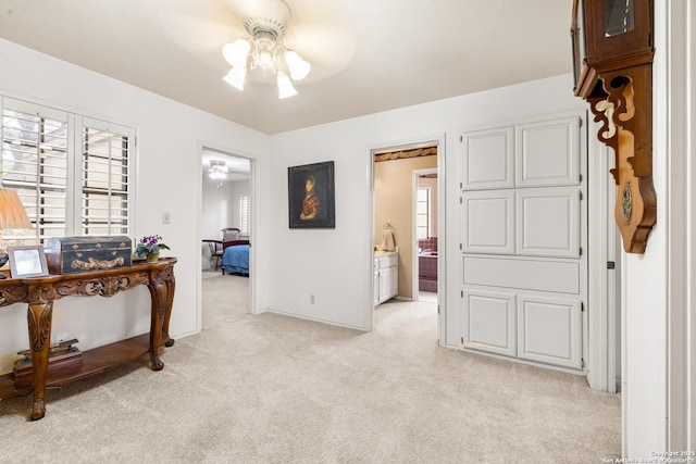 hallway featuring light colored carpet