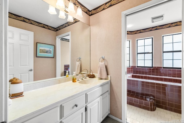 bathroom with visible vents, a notable chandelier, and vanity