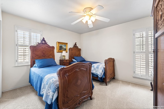 bedroom featuring ceiling fan and light colored carpet