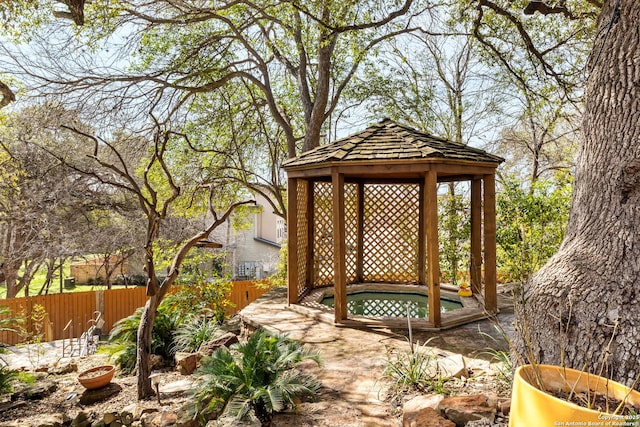 exterior space featuring fence and a gazebo