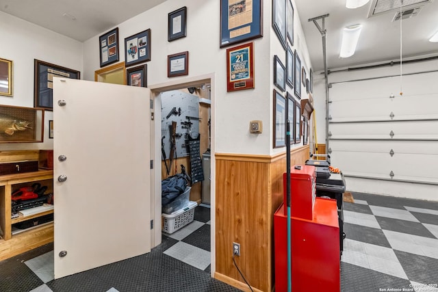 garage with a wainscoted wall and wooden walls