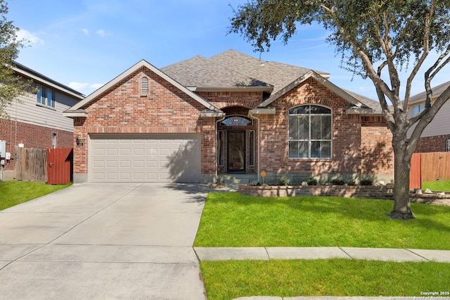 ranch-style house featuring a garage, driveway, brick siding, and a front yard