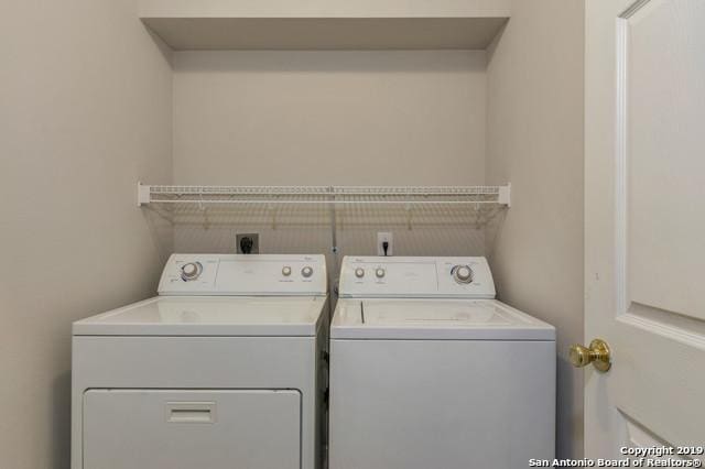 clothes washing area featuring laundry area and washing machine and clothes dryer