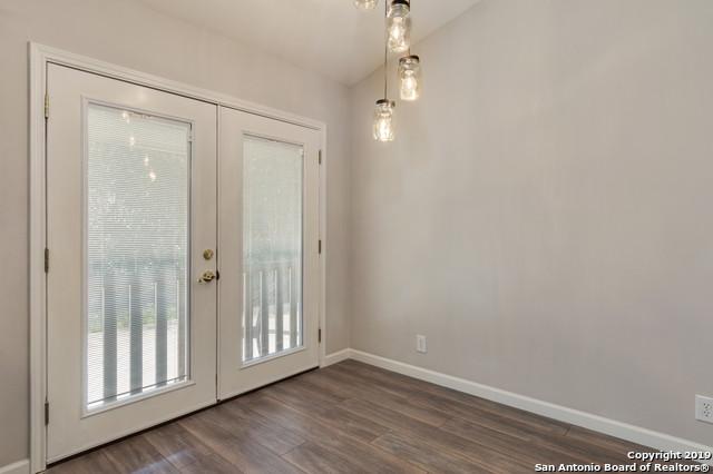 doorway to outside featuring french doors, baseboards, vaulted ceiling, and dark wood-style flooring