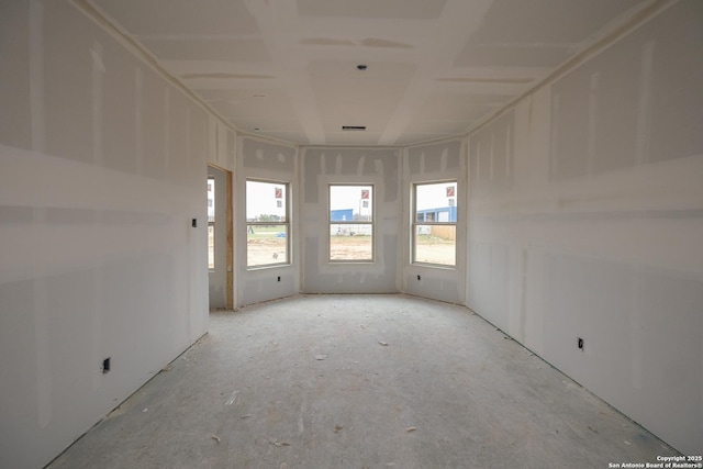 empty room with a healthy amount of sunlight and visible vents