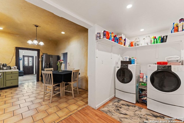 clothes washing area featuring recessed lighting, light wood-style flooring, a notable chandelier, and independent washer and dryer