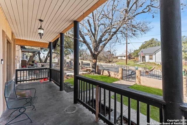 balcony featuring covered porch and a residential view