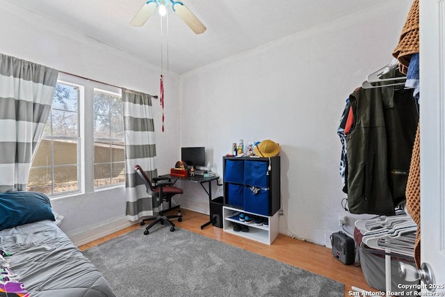 home office with a ceiling fan and wood finished floors