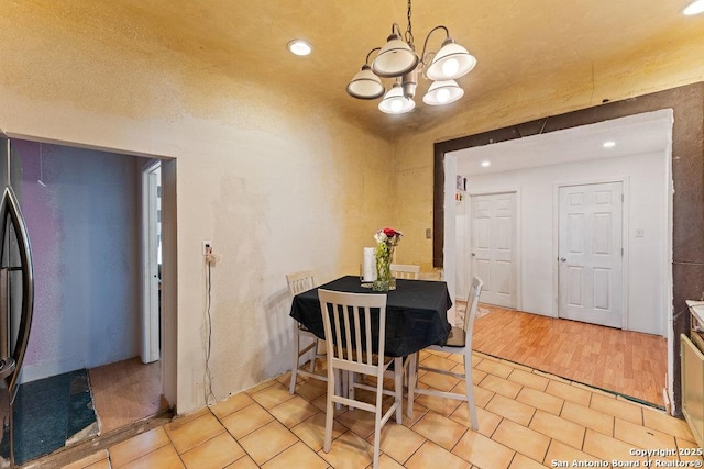 dining space featuring a chandelier and light tile patterned flooring