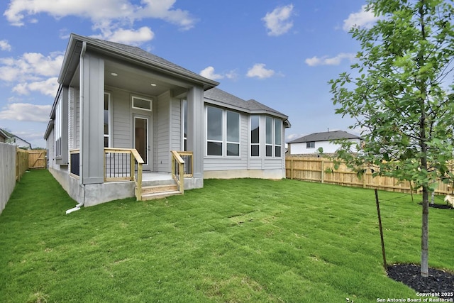 12440 Lanthimos, San Antonio, TX 78254 - rear view of house featuring a lawn, a fenced backyard, and roof with shingles