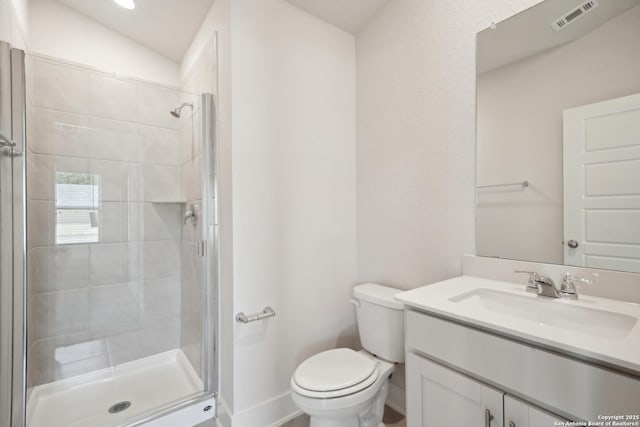 full bathroom featuring toilet, vanity, a shower stall, and visible vents