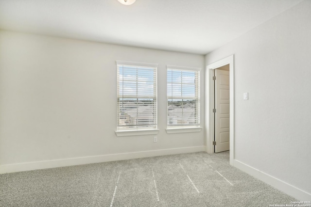 empty room with light carpet and baseboards