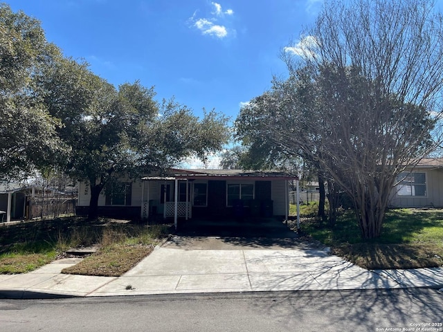 view of front of house featuring a carport and concrete driveway