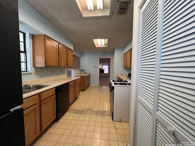 kitchen with light floors, visible vents, light countertops, black appliances, and brown cabinetry