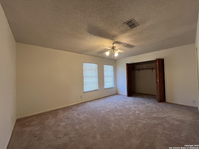 unfurnished bedroom featuring carpet, a closet, visible vents, a ceiling fan, and baseboards