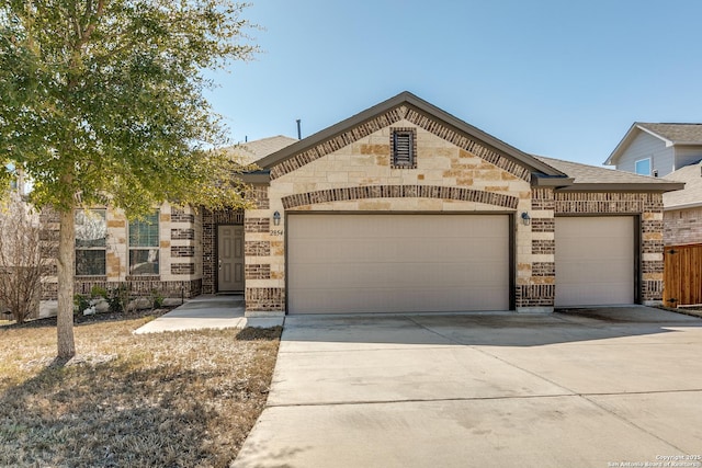 view of front facade featuring a garage, driveway, a shingled roof, and brick siding