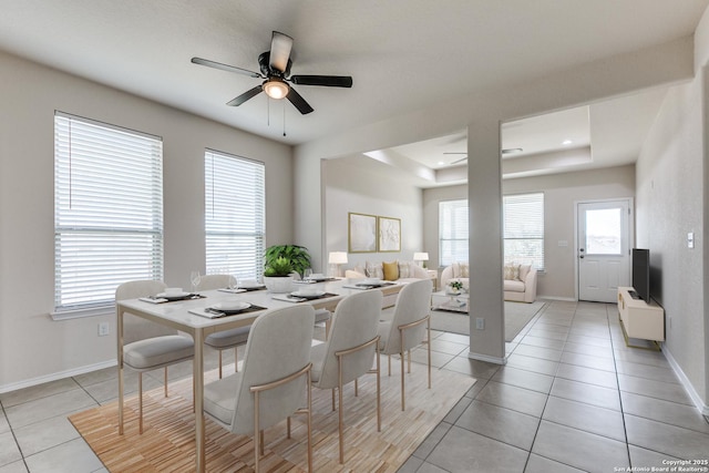 dining area with light tile patterned floors, baseboards, ceiling fan, a tray ceiling, and recessed lighting