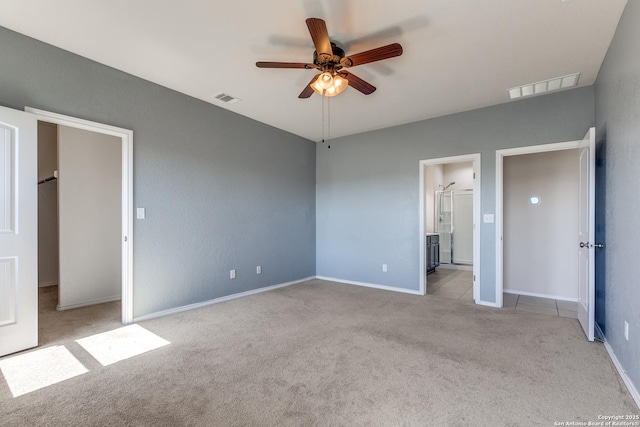 unfurnished bedroom featuring ensuite bathroom, carpet floors, ceiling fan, and visible vents