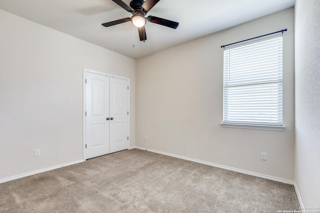 unfurnished bedroom featuring a closet, baseboards, and carpet flooring