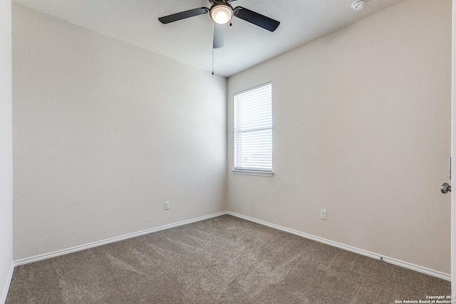 carpeted empty room with ceiling fan and baseboards