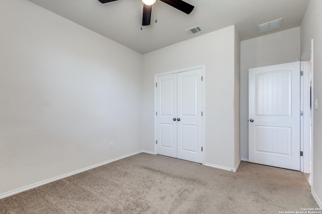 unfurnished bedroom with carpet floors, visible vents, and baseboards