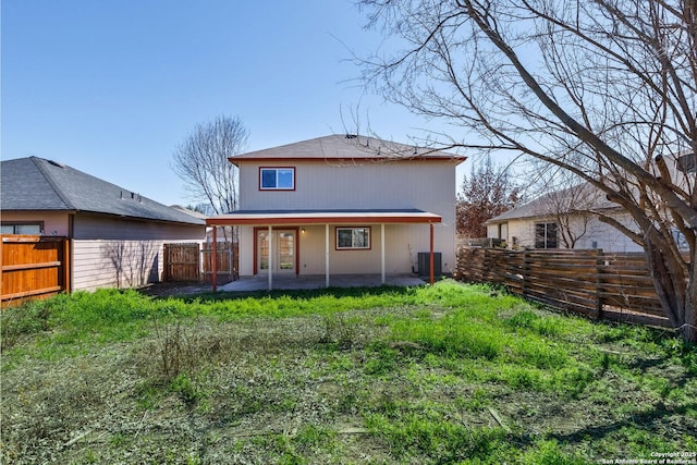 rear view of property featuring a patio, french doors, a fenced backyard, and cooling unit