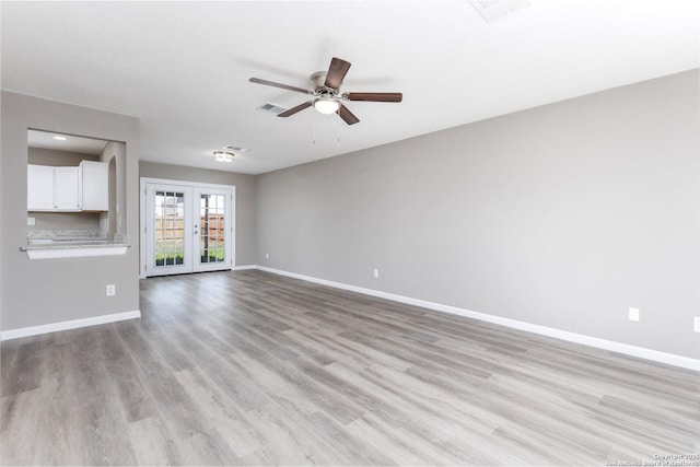 unfurnished living room with a ceiling fan, visible vents, baseboards, french doors, and light wood finished floors