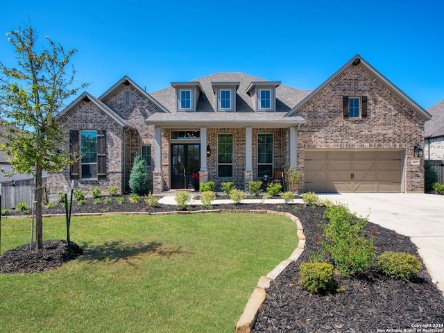 craftsman house with a porch, brick siding, fence, concrete driveway, and a front yard